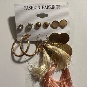Assortment of posts and fringe earrings on cards.